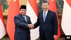 Chinese President Xi Jinping, at right, shakes hands with Indonesian President-elect Prabowo Subianto at the Great Hall of the People in Beijing on April 1, 2024, in this photo released by Xinhua News Agency.