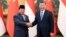 Chinese President Xi Jinping, at right, shakes hands with Indonesian President-elect Prabowo Subianto at the Great Hall of the People in Beijing on April 1, 2024, in this photo released by Xinhua News Agency.