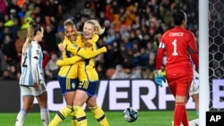 Sweden's Rebecka Blomqvist, center, embraces teammate Madelen Janogy after scoring her team's first goal during the Women's World Cup Group G soccer match between Argentina and Sweden in Hamilton, New Zealand, Aug. 2, 2023.