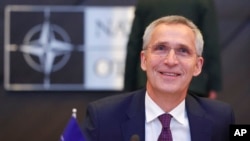 FILE - NATO Secretary-General Jens Stoltenberg smiles during the North Atlantic Council round table meeting of NATO defense ministers at NATO headquarters in Brussels, Feb. 15, 2023.