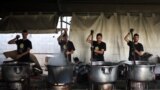 Local volunteers of the World Central Kitchen cook meals to be distributed to needy Palestinians in Rafah in the southern Gaza Strip.