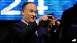 Douglas Emhoff gestures as his wife Democratic presidential nominee Vice President Kamala Harris walks on the stage during the Democratic National Convention, Aug. 19, 2024, in Chicago.