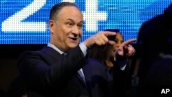 Douglas Emhoff gestures as his wife Democratic presidential nominee Vice President Kamala Harris walks on the stage during the Democratic National Convention, Aug. 19, 2024, in Chicago.