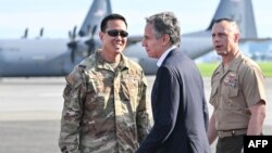 US Secretary of State Antony Blinken, center, is welcomed upon arrival for the start of his two-day visit, at Yokota Air Base in Fussa, western Tokyo, on July 28, 2024. 