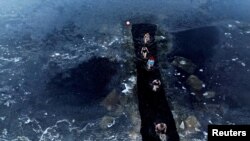 Ice swimmer Fenwick Ridley takes a cold water swim class into a manmade ice channel in Sweethope Loughs in Harle, Northumberland, Britain.