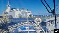 In this photo provided by the Philippine Coast Guard, a Chinese coast guard ship, front, allegedly blocks the path of a Philippine coast guard ship near the Philippine-occupied Second Thomas Shoal, South China Sea, during a resupply mission Aug. 5, 2023.