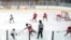FILE - Players on the Minneapolis, wearing white and black uniforms, and Orono, wearing red uniforms, teams compete in a 10-and-under youth hockey game in Minneapolis, Feb. 4, 2024.