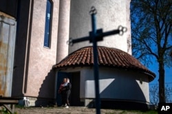 Christian Orthodox worshippers leave the chapel basement after attending a service at the Church of the Intercession of the Blessed Virgin Mary in Lypivka near Kyiv, Ukraine, April 28, 2024.