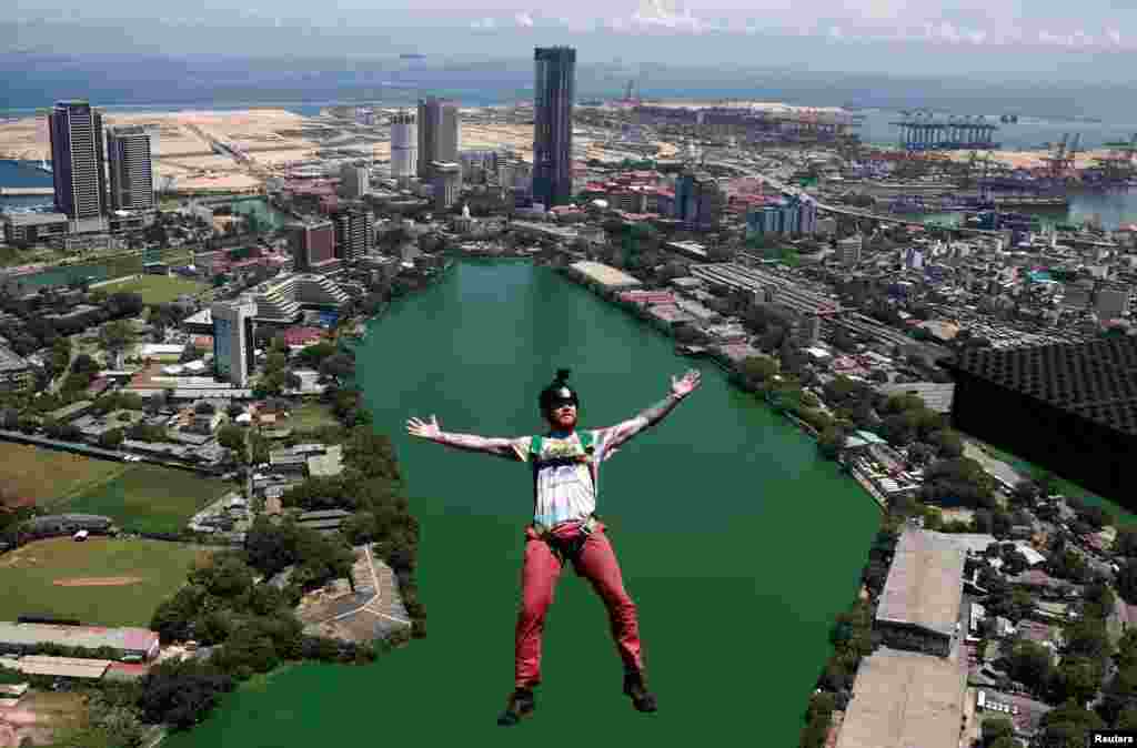 A base jumper leaps off the Lotus Tower, a 351.5 m tall tower in Colombo, Sri Lanka.