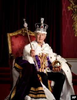 In this photo made available by Buckingham Palace on Monday, May 8, 2023, Britain's King Charles III poses for a photo in full regalia in the Throne Room, London. (Hugo Burnand/Royal Household 2023 via AP)