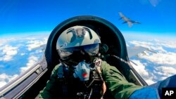 In this Xinhua News Agency photo, a Chinese fighter jet pilot takes part in combat readiness patrol and military exercises around the Taiwan Island on Sunday, April 9, 2023. (Mei Shaoquan/Xinhua via AP)