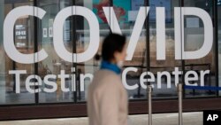 FILE - A woman walks outside of a COVID-19 testing center at the Incheon International Airport In Incheon, South Korea, on Feb. 10, 2023.