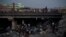 FILE - Afghans gather under a bridge to consume drugs, mostly heroin and methamphetamines in Kabul, Afghanistan, on Sept. 30, 2021. 