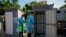 UNICEF health care workers sanitize bathrooms as part of a cholera outbreak containment response, at a Syrian refugee camp in Bhanine village, in the northern Akkar province, Lebanon, Oct. 18, 2022. 