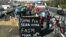 Farmers block A63 highway to protest over taxation and declining income, near Bayonne, on Jan. 23, 2024. The sign says "Our end will be your hunger." 
