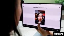 Kwon Hyo-jin takes a photo for virtual makeup to analyze her skin color using AI technology, to get a color for lipstick at Amore Seongsu in Seoul, South Korea, June 7, 2024. (REUTERS/Kim Soo-hyeon)