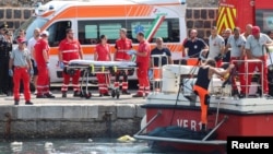 Italian firefighters transport a body bag after a sailboat sank in the early hours of Monday, off the coast of Ponticello, near the Sicilian city of Palermo, Italy, Aug. 19, 2024.