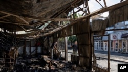 People clear the rubble of a market destroyed in a rocket attack the day before in Kostiantynivka, Ukraine, Sept. 7, 2023. At least 17 people were killed and 32 wounded in Wednesday’s attack on the market in Ukraine’s Donetsk region.