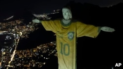 The Christ the redeemer statue is illuminated with an image of Pele's Brazilian jersey, as a tribute to the soccer legend on his one-year death anniversary, in Rio de Janeiro, Brazil, Dec. 29, 2023.