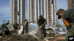 Soldiers gather debris in the aftermath of Hurricane Otis in Acapulco, Mexico, Oct. 28, 2023.