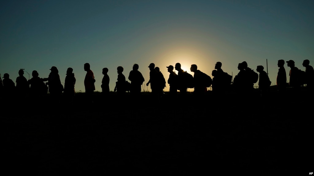 资料照片：2023年9月23日，在德克萨斯州伊格尔帕斯，越过里奥格兰德河并从墨西哥进入美国的移民正在排队等待美国海关和边境保护局的处理。（美联社照片）(photo:VOA)