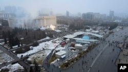 Smoke rises from the city hall building during a protest in Almaty, Kazakhstan, Wednesday, Jan. 5, 2022.