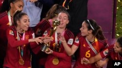 From left to right, Spain's Olga Carmona, Eva Navarro, Aitana Bonmati and Alba Redondo celebrate with their trophy after winning the Women's World Cup soccer final against England at Stadium Australia in Sydney, Aug. 20, 2023.