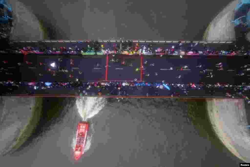 General view shows participants running over Tower Bridge during the London Marathon.