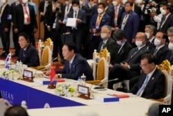 FILE - South Korea's President Yoon Suk Yeol, center, speak as Japan's Prime Minister Fumio Kishida, left, and China's Premier Li Keqiang listen to during the ASEAN Plus Three Summits in Phnom Penh, Cambodia, on Nov. 12, 2022.