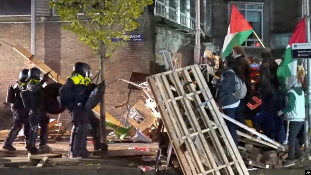 In this image from video, police move in to arrests dozens of activists as they break up a pro-Palestinian protest camp at the University of Amsterdam, in Amsterdam, Netherlands, May 7, 2024. (AP Photo/InterVision)