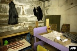 A child's bed stands in the area of a room reportedly used as a temporary morgue, in the basement of the Yahidne School, which is being turned into a museum, in Yahidne, Sept. 7, 2023.