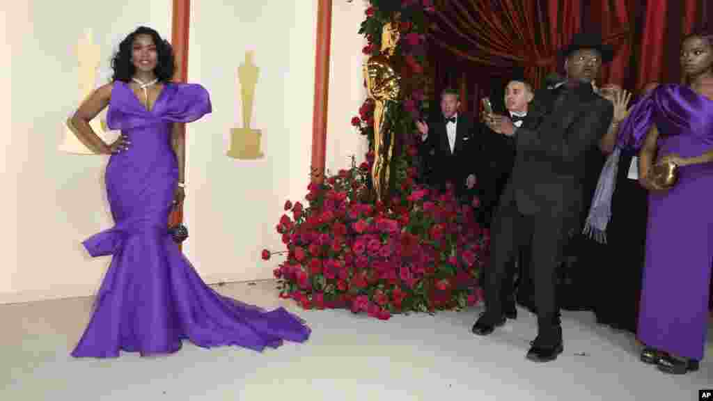 Angela Bassett, left, and Courtney B. Vance, as he takes her picture, arrive at the Oscars on Sunday, March 12, 2023, at the Dolby Theatre in Los Angeles. (Photo by Jordan Strauss/Invision/AP)