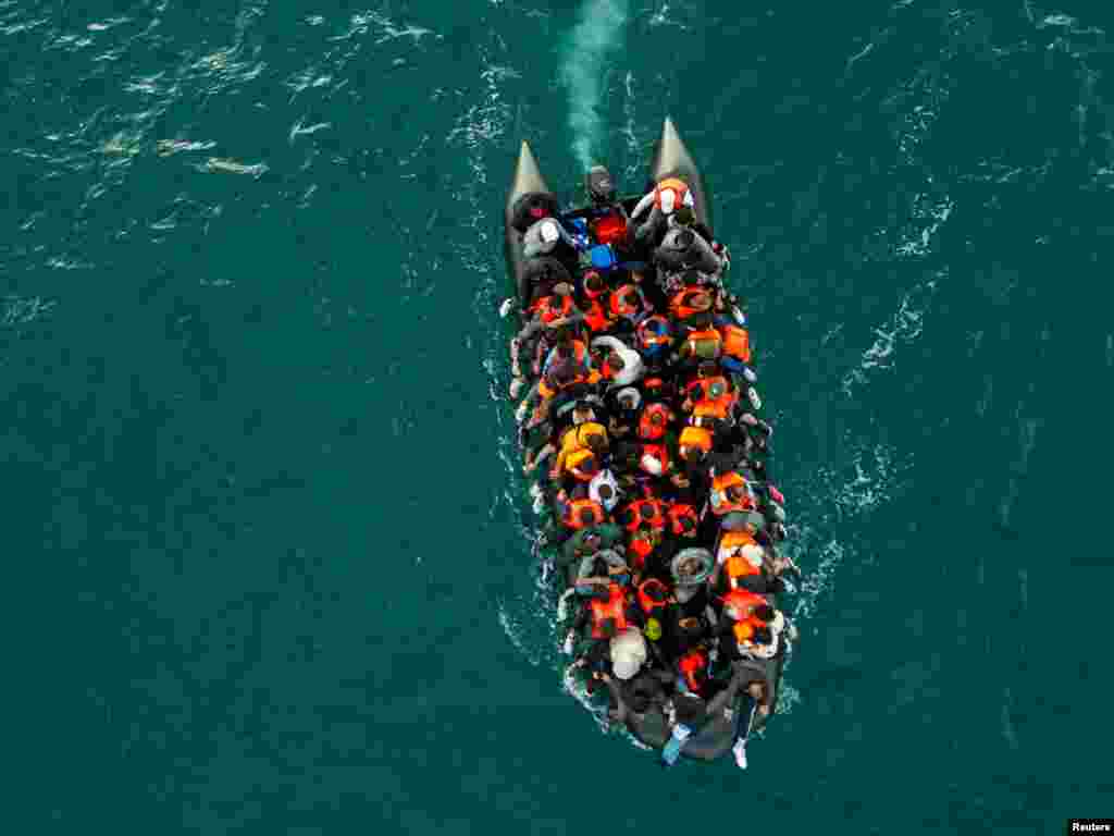 In this drone view an inflatable dinghy carrying migrants makes its way towards England in the English Channel, Britain.