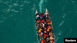 In this drone view an inflatable dinghy carrying migrants makes its way towards England in the English Channel, Britain.