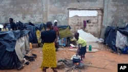 Migrants in Niamey, Niger, prepare food in their makeshift camp, Aug. 22, 2023. Some 7,000 migrants are stranded in Niger, unable to go home because of border closures and travel and economic sanctions imposed after last month's coup. 