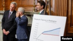 U.S. House Speaker Kevin McCarthy listens to U.S. Representative Patrick McHenry during a press conference at the U.S. Capitol in Washington after the House approved the debt ceiling deal he negotiated with the White House, May 31, 2023.