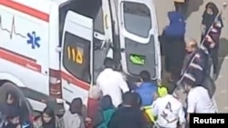 A person is lifted to an ambulance outside a girls' school after reports of poisoning in Ardabil, Iran, in this still image from undated video released March 1, 2023, and obtained by Reuters.