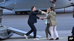 FILE - Belgium's Olivier Vandecasteele, left, is greeted by his family after landing at Melsbroek military airport in Melsbroek, Belgium, May 26, 2023. He was detained in Iran for nearly 15 months.