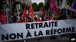 French union demonstrators protest President Emmanuel Macron's pension reform during the 76th edition of the Cannes Film Festival in Cannes, May 21, 2023. 