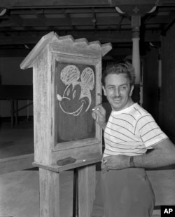 FILE - Walt Disney, creator of Mickey Mouse, poses for a photo at the Pancoast Hotel, Aug. 13, 1941, in Miami, Fla. The earliest version of Mickey Mouse will become public domain on Jan. 1, 2024. (AP Photo, File)