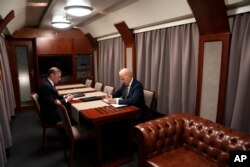 President Joe Biden sits on a train with National Security Advisor Jake Sullivan as he goes over his speech marking the one-year anniversary of the war in Ukraine after a surprise visit with Ukrainian President Volodymyr Zelenskyy, Monday, Feb. 20, 2023, in Kyiv. (AP Photo/ Evan Vucci)