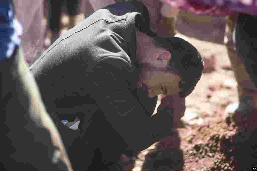 A man weeps after burying his brother who was killed by the earthquake, in Ouargane village, near Marrakech, Morocco, Sept. 9, 2023.