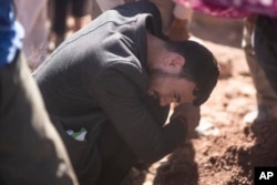 A man weeps after burying his brother who was killed by the earthquake, in Ouargane village, near Marrakech, Morocco, Sept. 9, 2023.