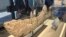 Researchers and students get a closer look at the jaw bone of a new subspecies of tyrannosaur unveiled at the New Mexico Museum of Natural History and Science in Albuquerque, Jan. 11, 2024.