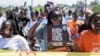 FILE - Activists protest to demand action on climate change, in downtown Kisumu, Kenya, April 19, 2024.