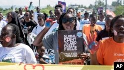 FILE - Activists protest to demand action on climate change, in downtown Kisumu, Kenya, April 19, 2024.