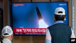 FILE - A TV screen shows a file image of a North Korean missile launch during a news program at the Seoul Railway Station, in Seoul, South Korea, May 17, 2024. 