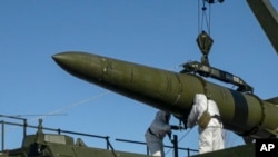 FILE - In this photo released by the Russian Defense Ministry on Feb. 2, 2024, Russian troops load an Iskander missile onto a mobile launcher during drills at an undisclosed location in Russia.