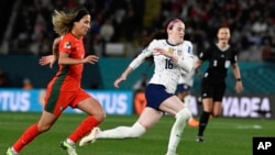 United States' Rose Lavelle runs clear of Portugal's Dolores Silva, left, during the Women's World Cup Group E soccer match between Portugal and the United States at Eden Park in Auckland, New Zealand, Aug. 1, 2023.