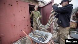 FILE - Ukrainian servicemen load ammunition near the frontline town of Bakhmut, Ukraine, April 12, 2023. NATO has warned that European ammunition stocks are running short as the West sends supplies to Ukraine to fend off invading Russian forces.